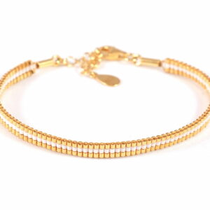 Pulsera de tres filas blanco perlado/oro con diseño de líneas lingitudinales